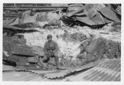 img145-Soldier-in-front-of-bombed-buildings